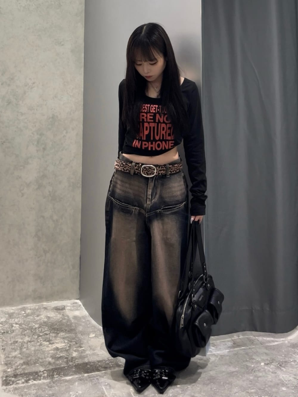 ブラック系のTシャツ/カットソー、ブルー系のデニムパンツ、ブラック系のパンプスを着用したレディースの秋コーディネートの2枚目の写真