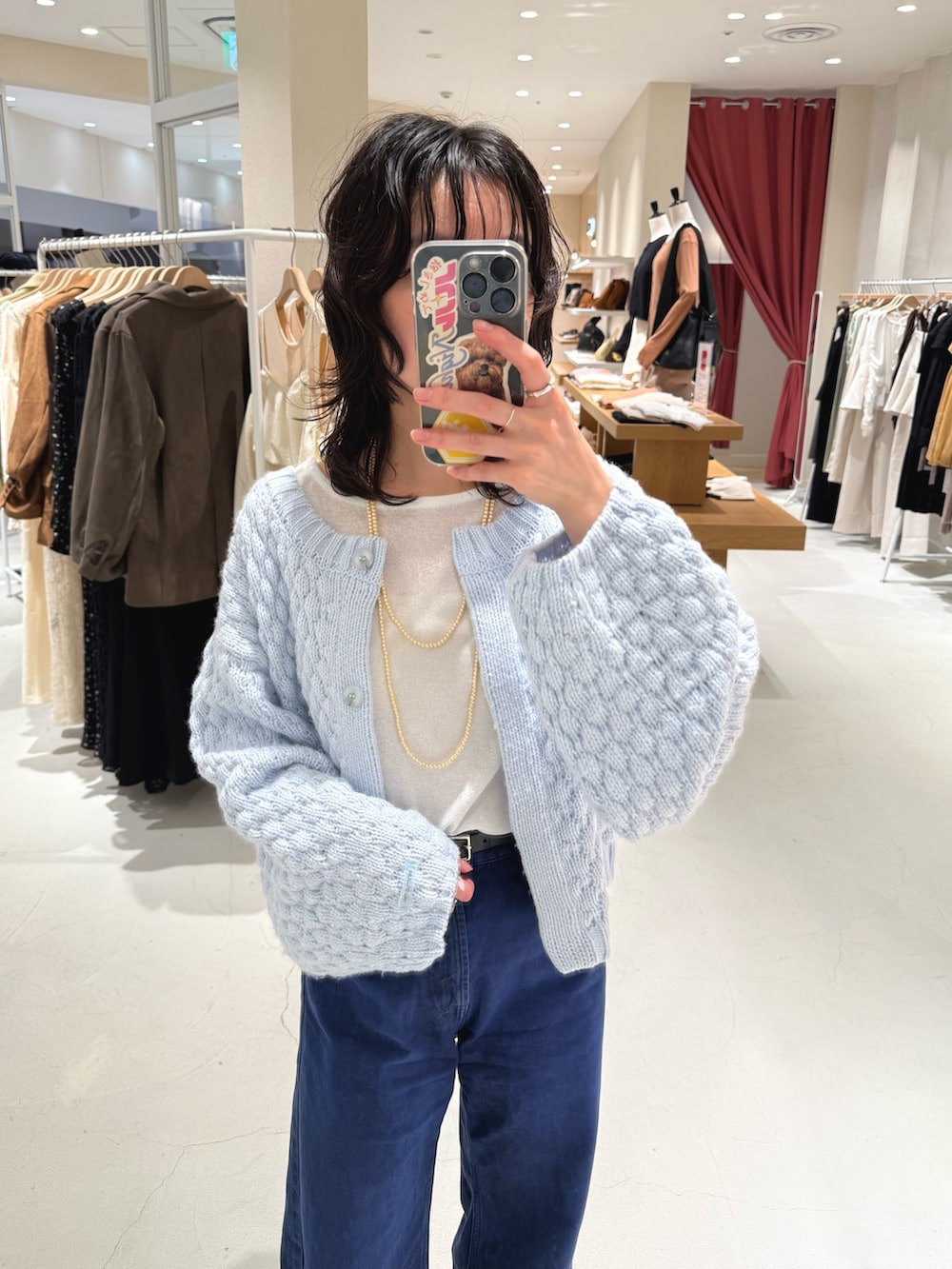 ブルー系のカーディガン/ボレロ、ホワイト系のTシャツ/カットソー、ブルー系のデニムパンツを着用したレディースの秋コーディネートの2枚目の写真