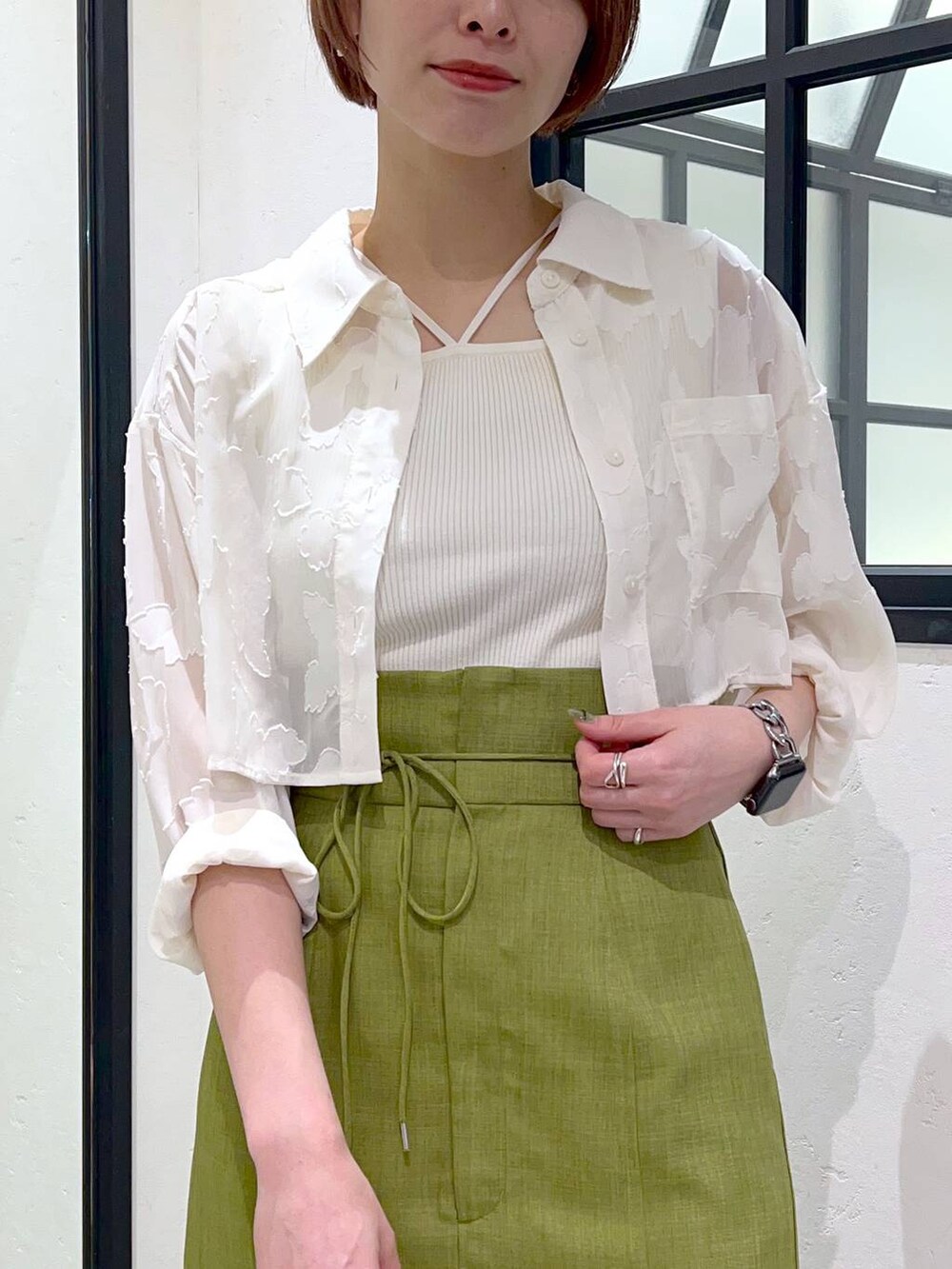 ホワイト系のタンクトップ、グリーン系のスカート、ホワイト系のワンピースを着用したレディースの春コーディネートの5枚目の写真