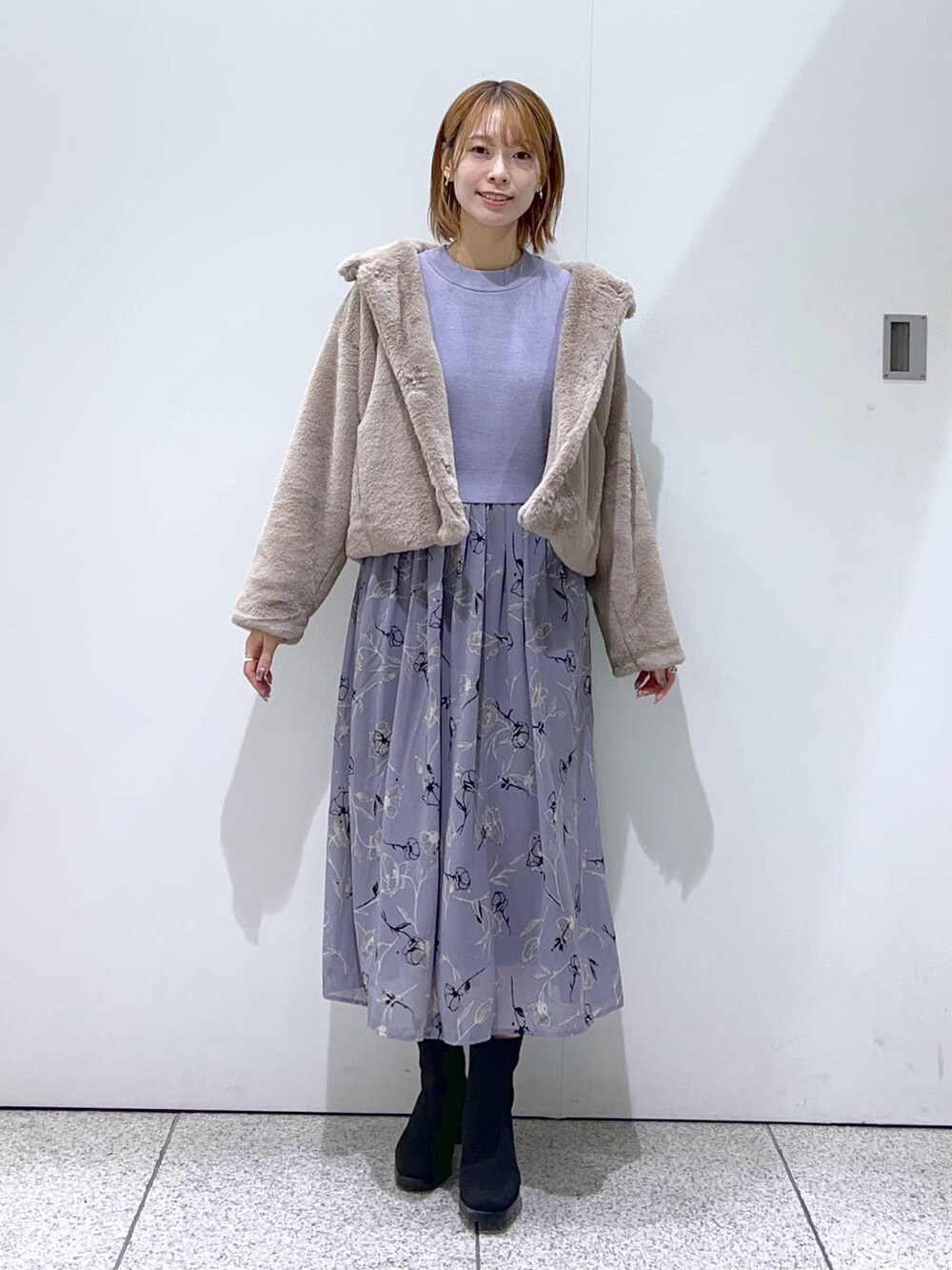 ブラック系のブーツ、ブルー系のワンピース、ホワイト系のショルダーバッグを着用したレディースの秋コーディネートの4枚目の写真