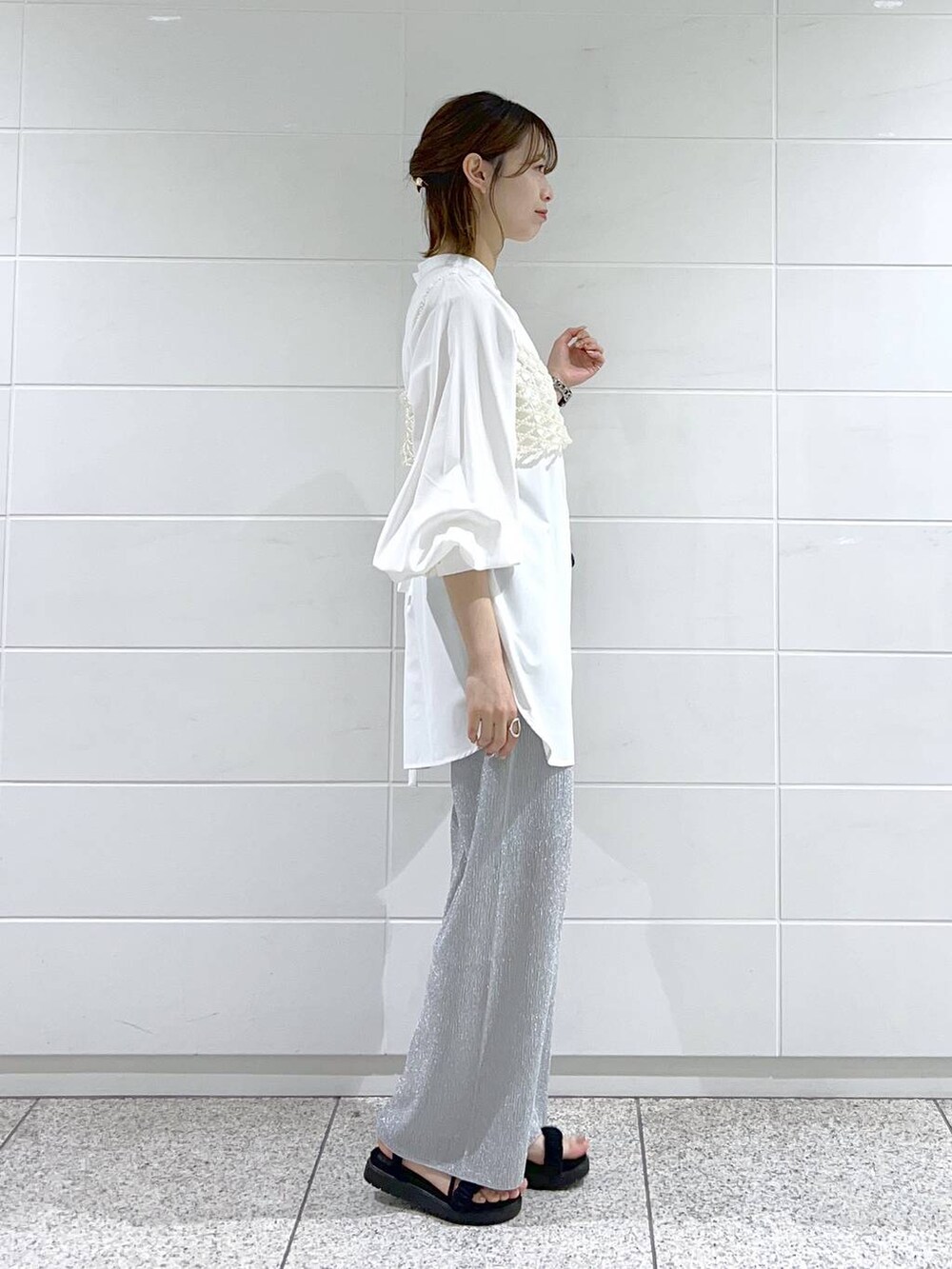 ホワイト系のシャツ/ブラウス、ホワイト系のベスト、ブラック系のサンダルを着用したレディースの春コーディネートの3枚目の写真