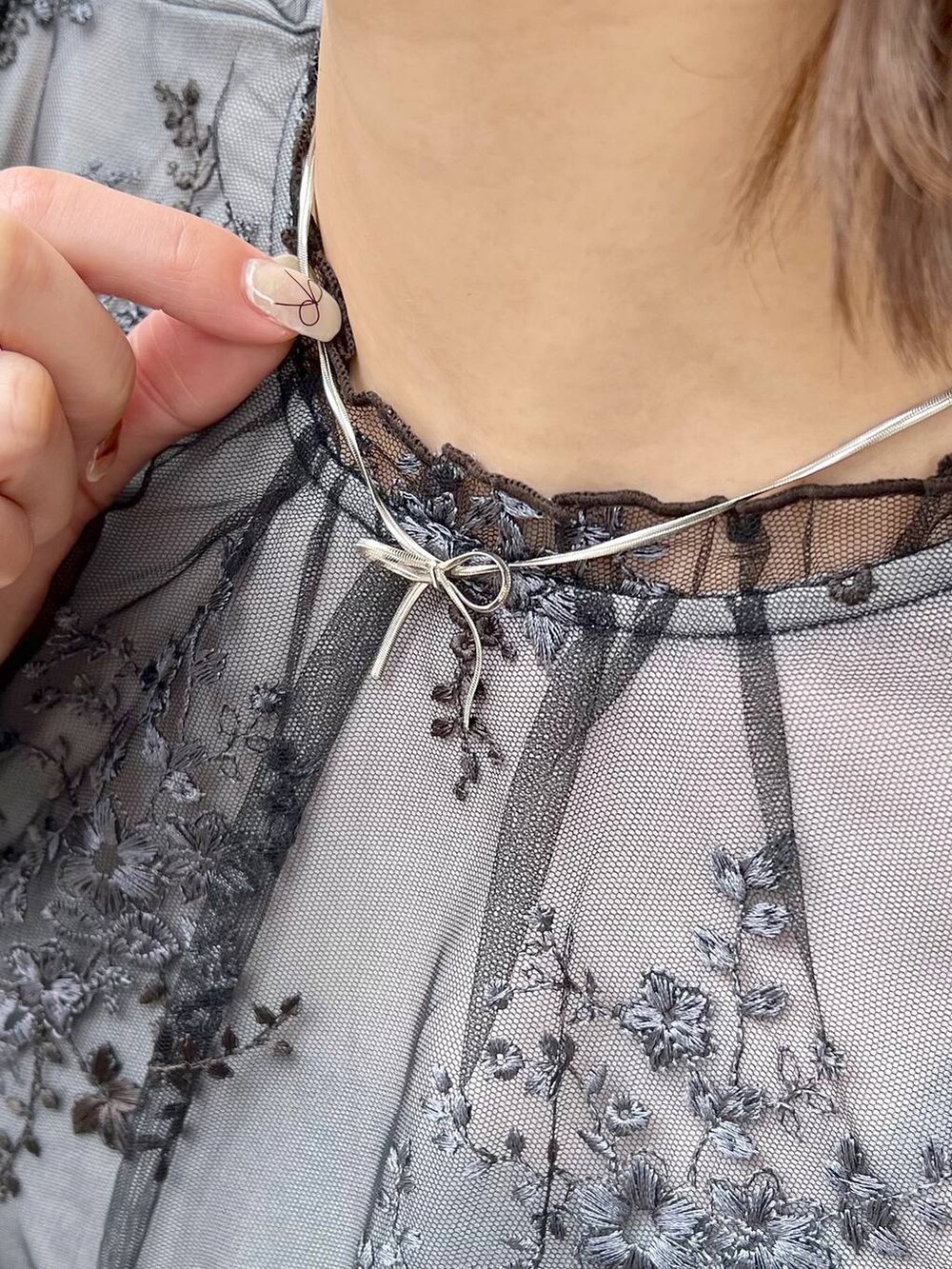 ブラック系のシャツ/ブラウス、ブラック系のサンダル、ブラック系のハンドバッグを着用したレディースの春コーディネートの7枚目の写真