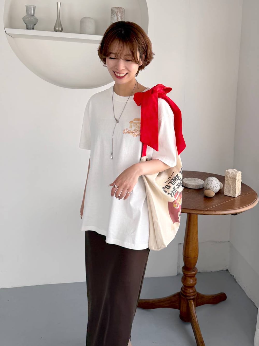 ベージュ系のサンダル、ホワイト系のトートバッグ、ホワイト系のTシャツ/カットソーを着用したレディースの夏コーディネートの4枚目の写真