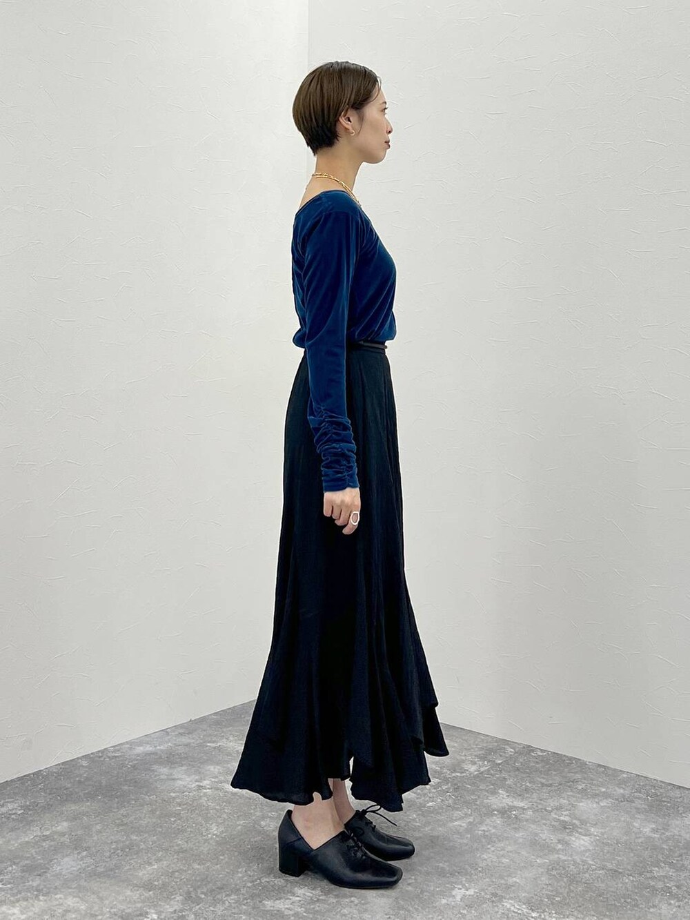 グレー系のテーラードジャケット、ブラック系のハンドバッグ、ブラック系のスカートを着用したレディースの秋コーディネートの6枚目の写真