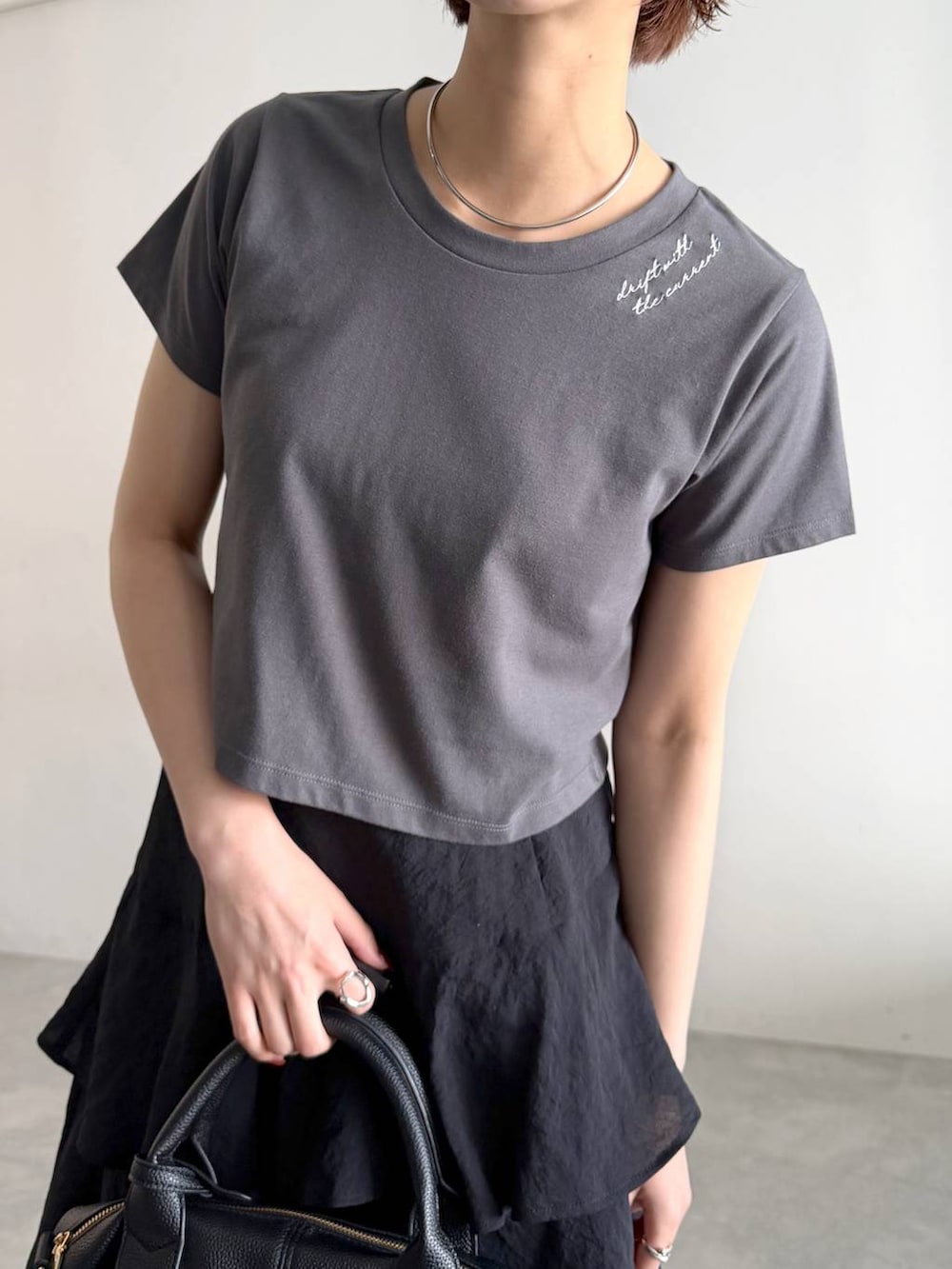 グレー系のTシャツ/カットソー、グリーン系のパーカー、ブラック系のスカートを着用したレディースの夏コーディネートの4枚目の写真