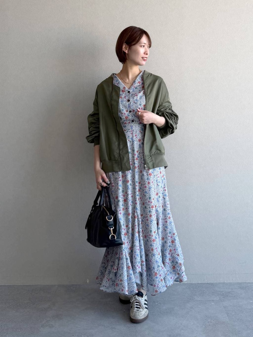 ブラック系のボストンバッグ、ホワイト系のワンピース、グリーン系のMA-1を着用したレディースの冬コーディネートの7枚目の写真