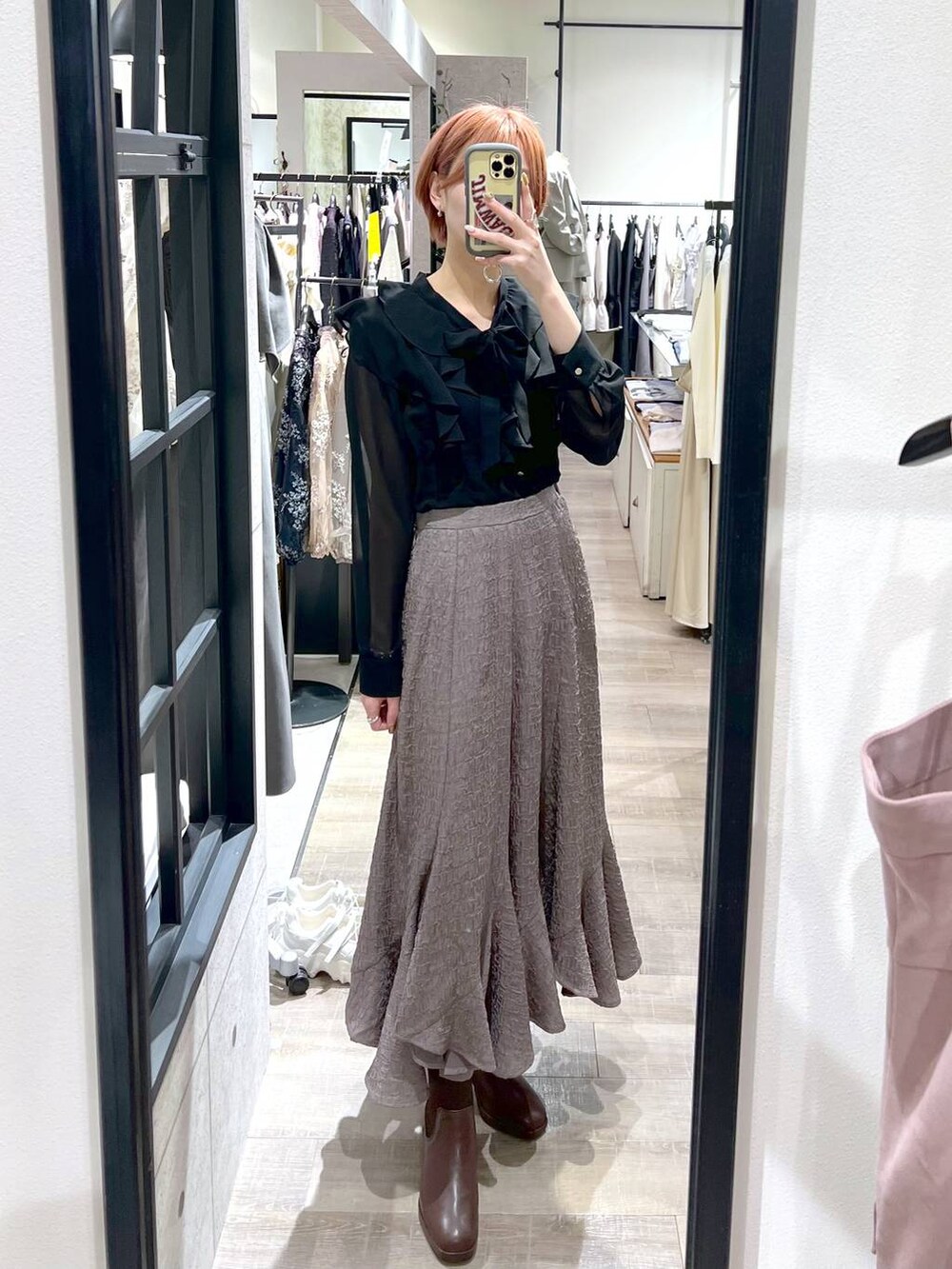 ブラウン系のブーツ、ホワイト系のショルダーバッグ、ブラック系のシャツ/ブラウスを着用したレディースの冬コーディネートの5枚目の写真