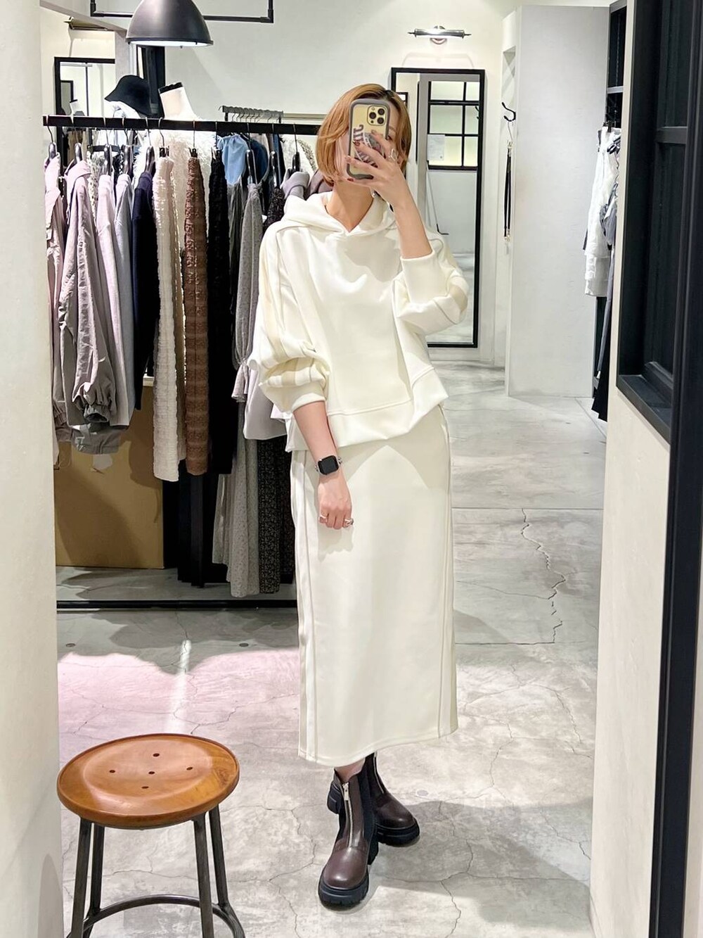 ベージュ系のピーコート、ホワイト系のショルダーバッグ、ブラウン系のブーツを着用したレディースの秋コーディネートの9枚目の写真