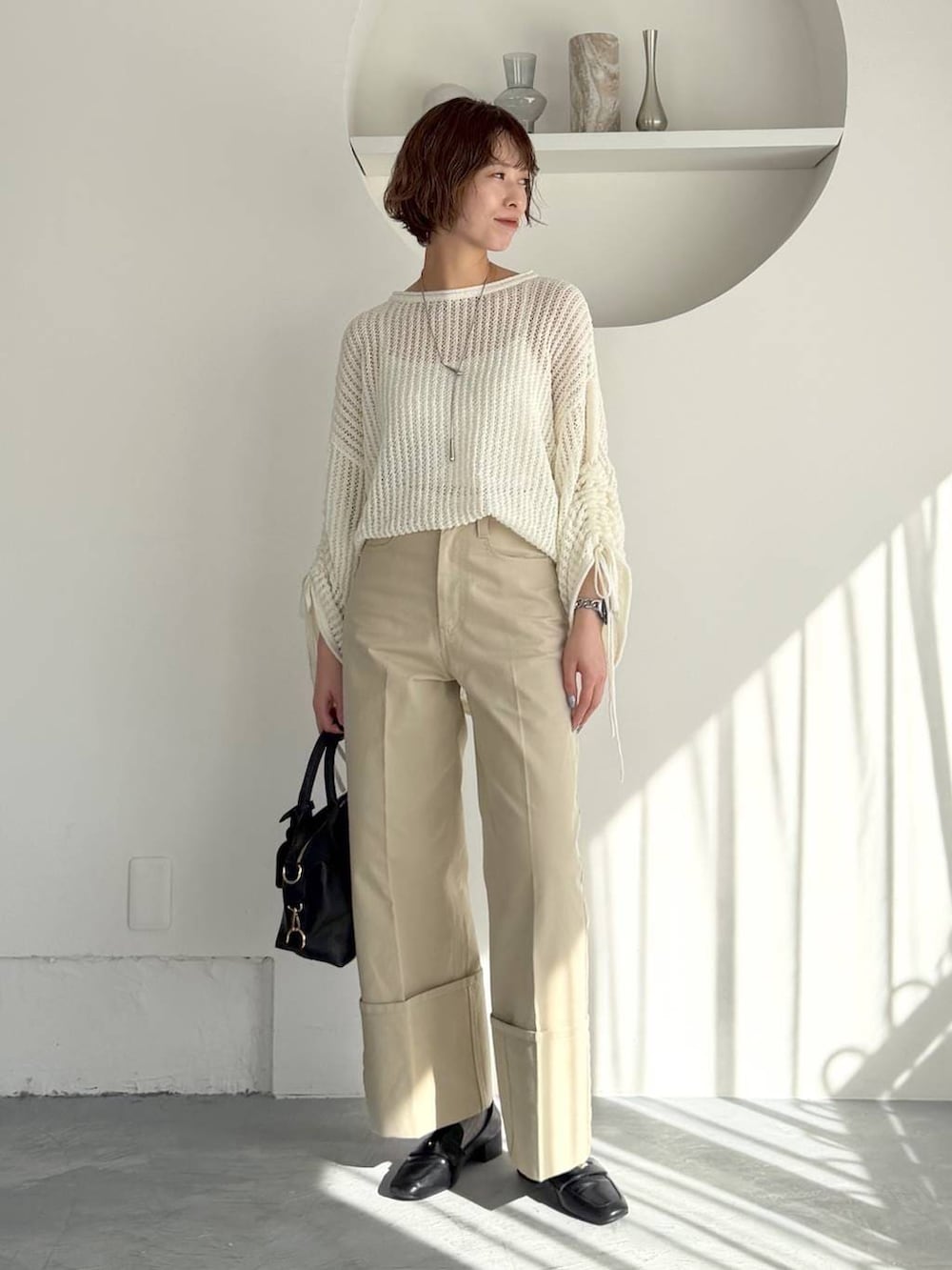 ブラック系のボストンバッグ、ブラック系のローファー、ブラック系のMA-1を着用したレディースの冬コーディネートの5枚目の写真