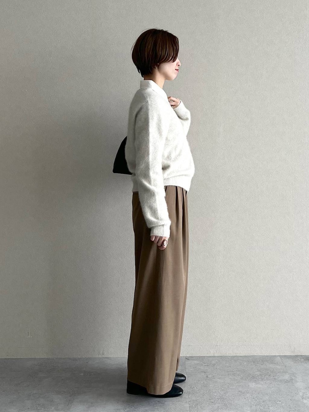 ブラック系のローファー、ブラック系のトートバッグ、ベージュ系のその他パンツを着用したレディースの秋コーディネートの2枚目の写真