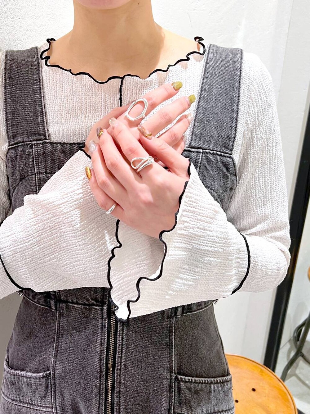 ブラック系のデニムジャケット、ブラック系のジャンパースカート、ブラック系のバレエシューズを着用したレディースの冬コーディネートの7枚目の写真
