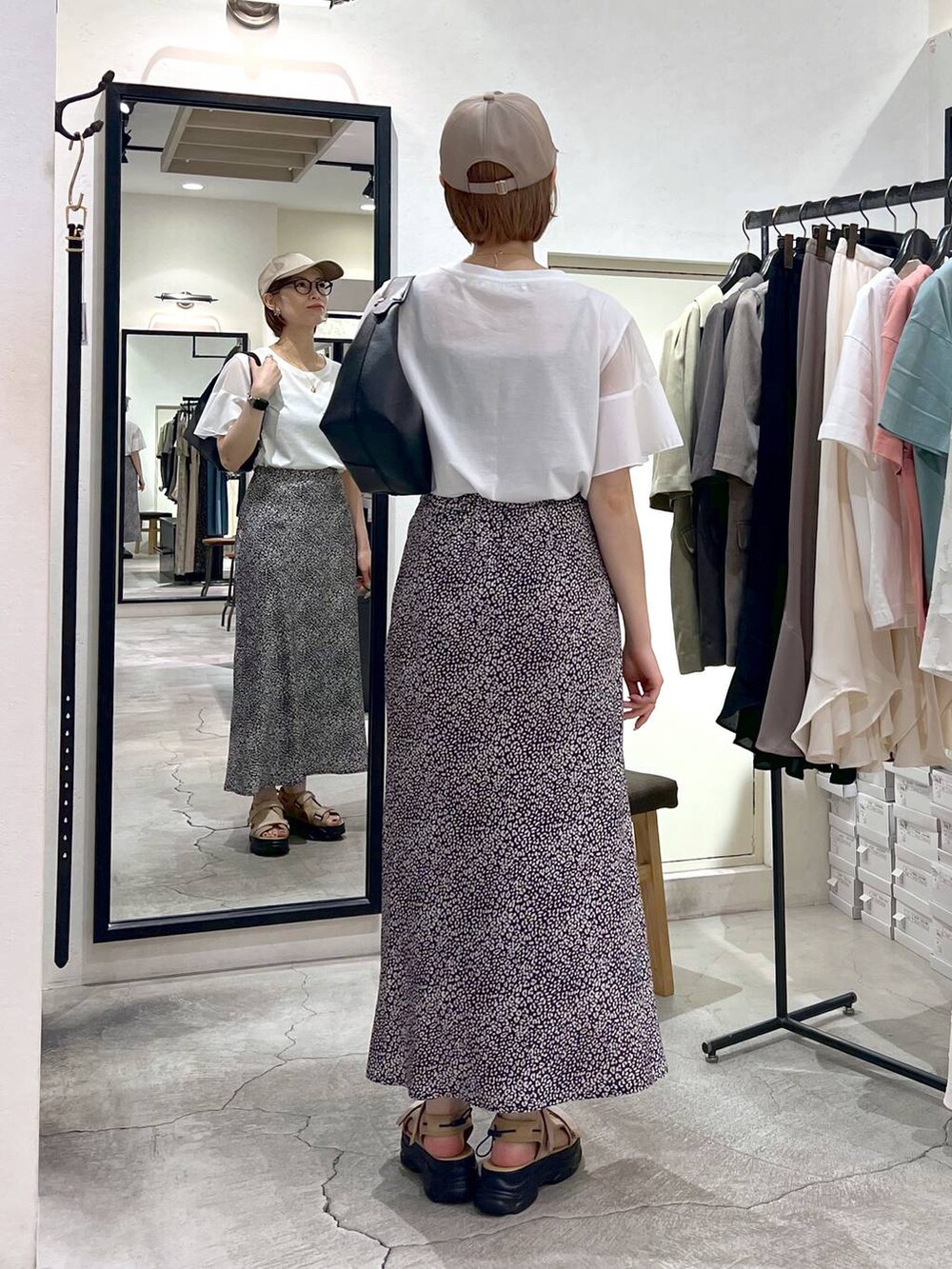 ベージュ系のサンダル、ホワイト系のTシャツ/カットソー、ブラック系のショルダーバッグを着用したレディースの夏コーディネートの3枚目の写真