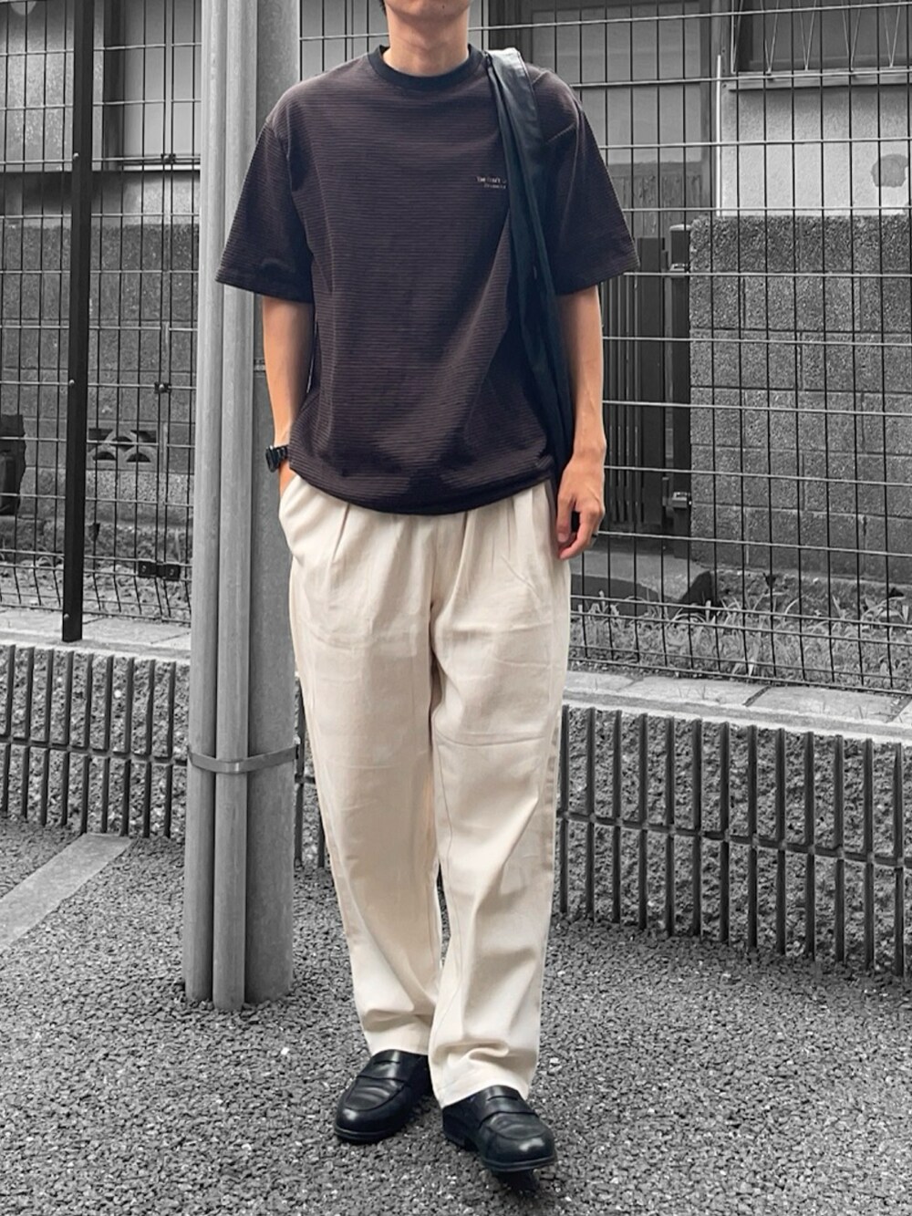 ブラウン系のTシャツ/カットソー、ブラック系のトートバッグ、ホワイト系のその他パンツを着用したメンズの夏コーディネートの2枚目の写真