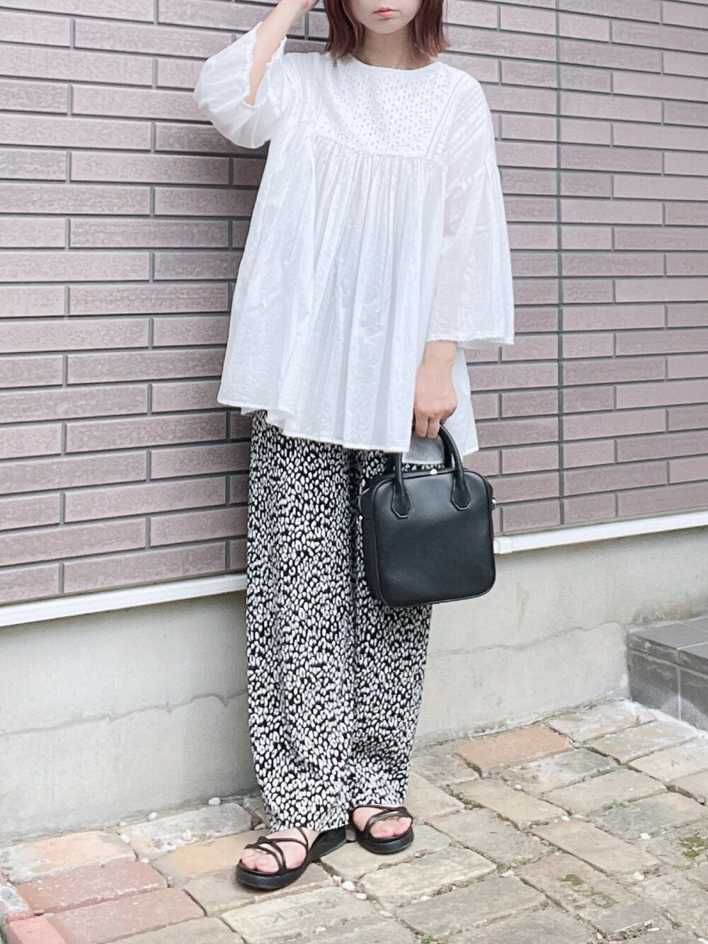 ブラック系のその他パンツ、ホワイト系のシャツ/ブラウス、ブラック系のボストンバッグを着用したレディースの夏コーディネートの2枚目の写真