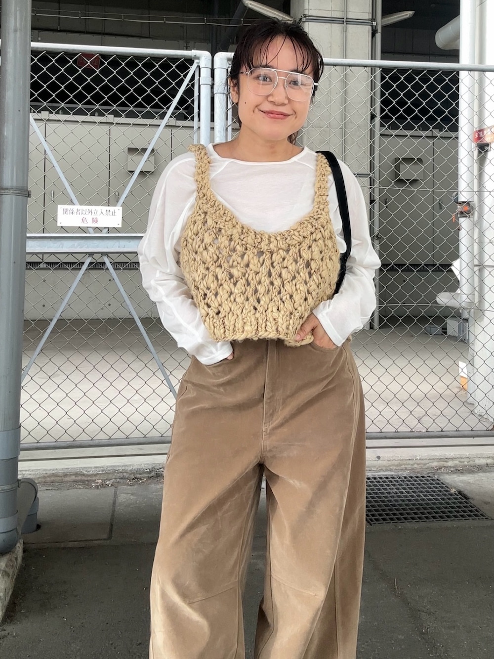ベージュ系のその他パンツ、ブラック系のサンダル、ホワイト系のTシャツ/カットソーを着用したレディースの秋コーディネートの3枚目の写真