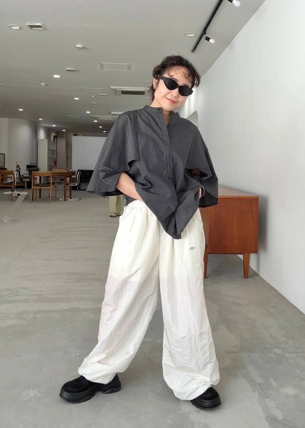 ホワイト系のその他パンツ、グレー系のシャツ/ブラウス、ブラック系のスニーカーを着用したレディースの夏コーディネートの6枚目の写真