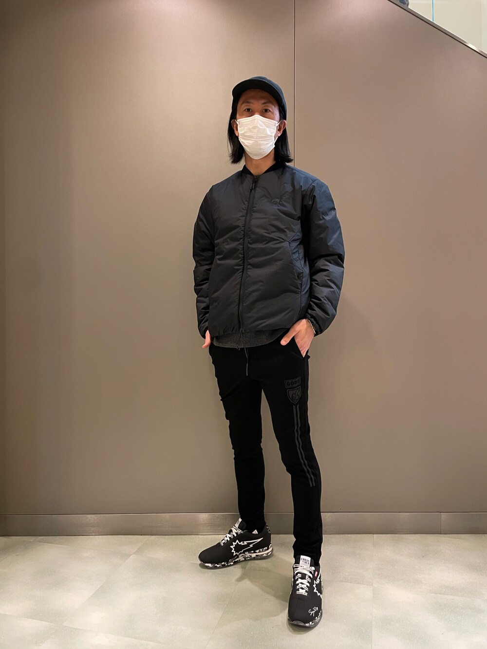 ブラック系のブルゾン、ブラック系のパンツ、ブラック系のスニーカーを着用したメンズの冬コーディネートの2枚目の写真