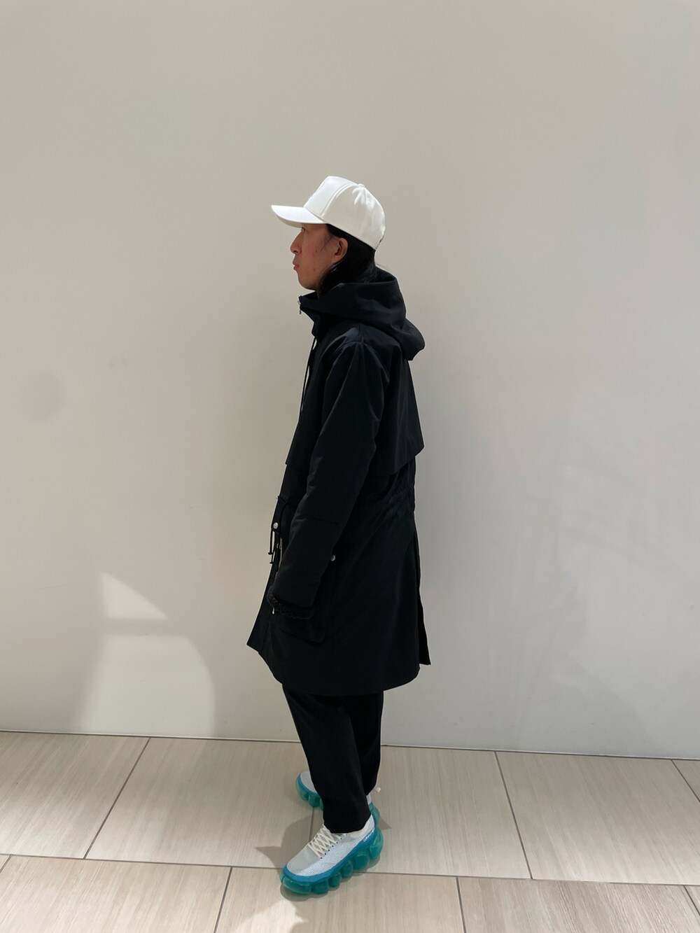 ブラック系のジャケット/アウター、ホワイト系のバッグ、ブルー系のスニーカーを着用したメンズの冬コーディネートの2枚目の写真