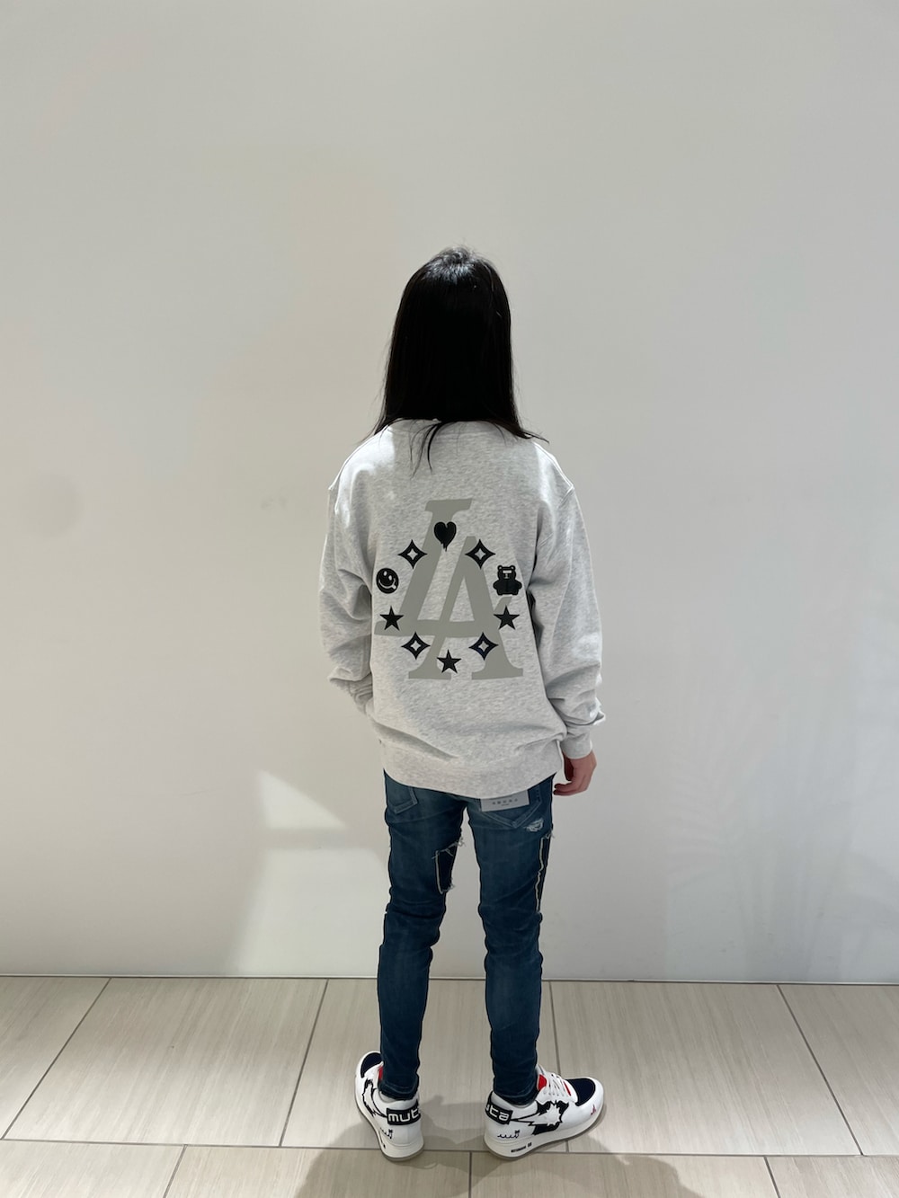 グレー系のスウェット、その他のデニムパンツ、ホワイト系のスニーカーを着用したメンズの冬コーディネートの2枚目の写真