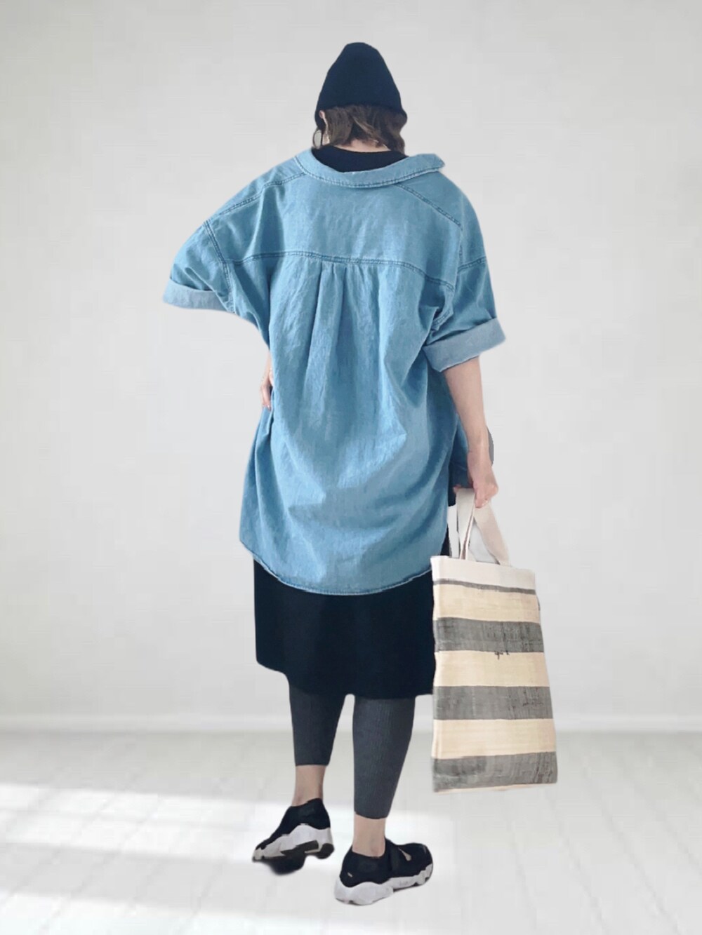 ブラック系のワンピース、ブルー系のシャツ/ブラウス、ブラック系のトートバッグを着用したレディースの夏コーディネートの2枚目の写真