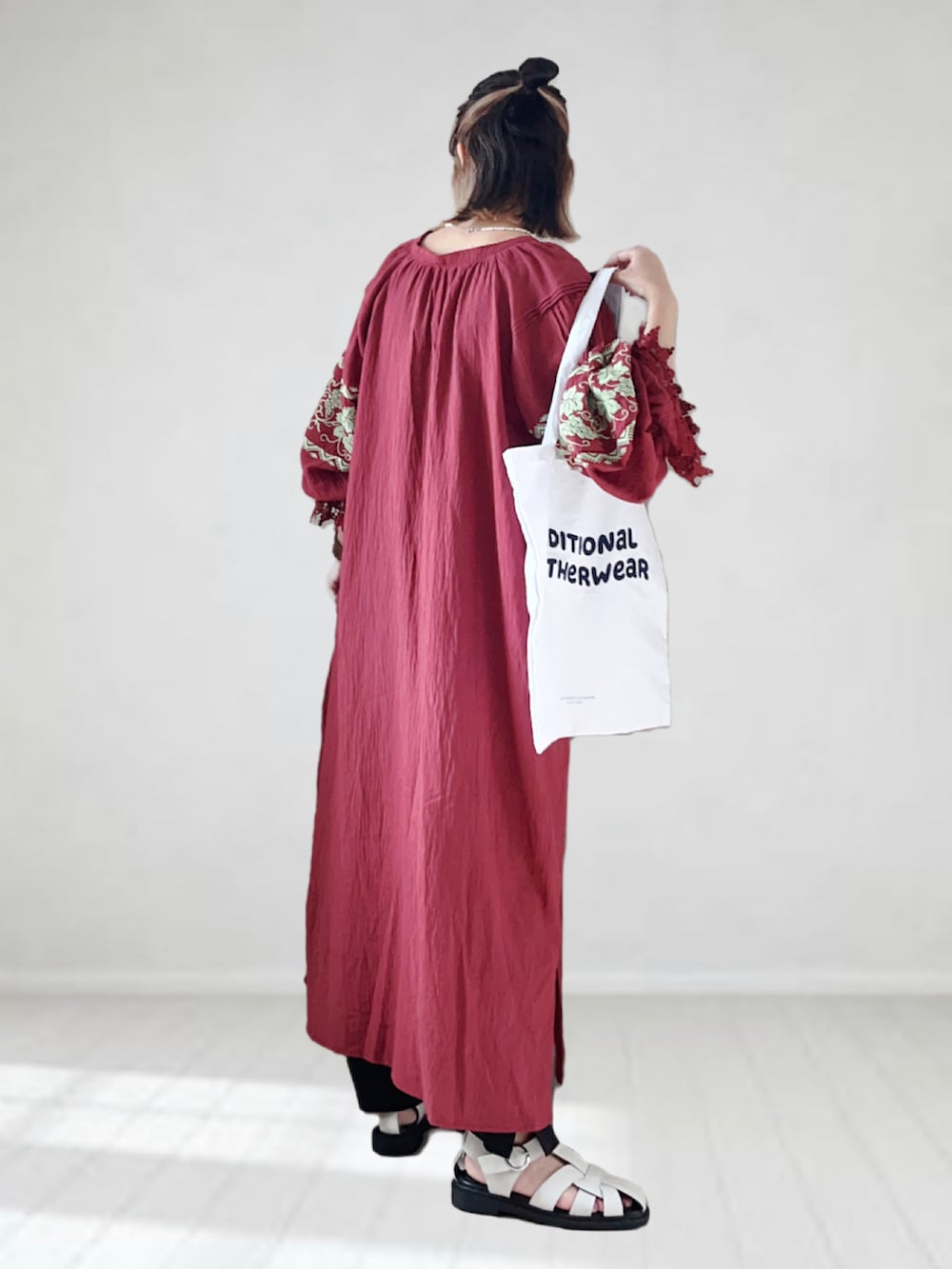 レッド系のワンピース、ブラック系のその他パンツ、ホワイト系のトートバッグを着用したレディースの夏コーディネートの2枚目の写真