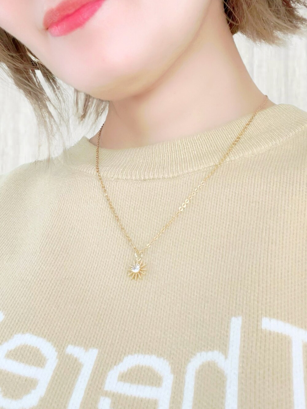 イエロー系のニット/セーター、グリーン系のショルダーバッグ、ブラウン系のスカートを着用したレディースの冬コーディネートの3枚目の写真