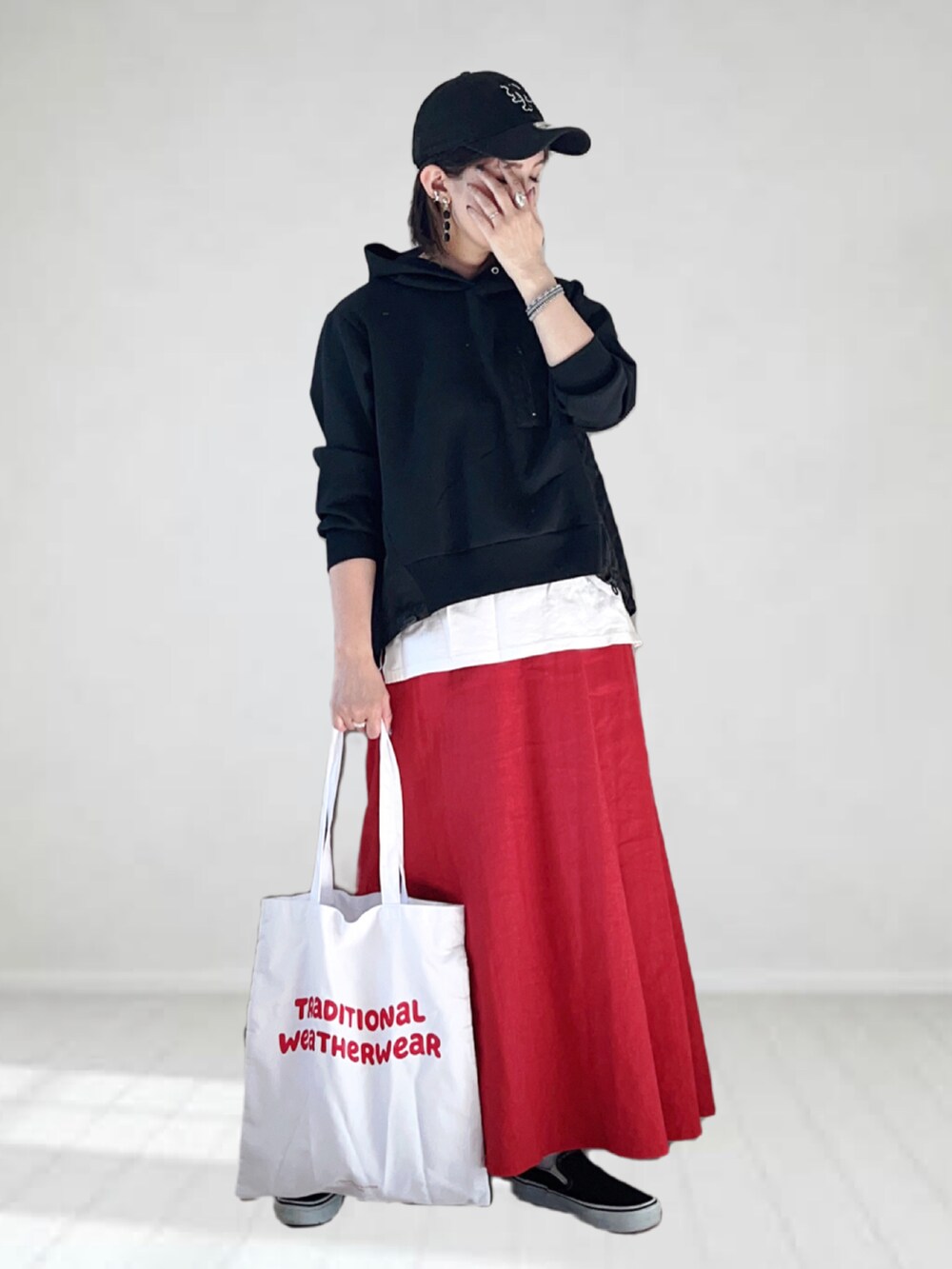 ホワイト系のTシャツ/カットソー、レッド系のスカート、レッド系のトートバッグを着用したレディースの夏コーディネートの2枚目の写真