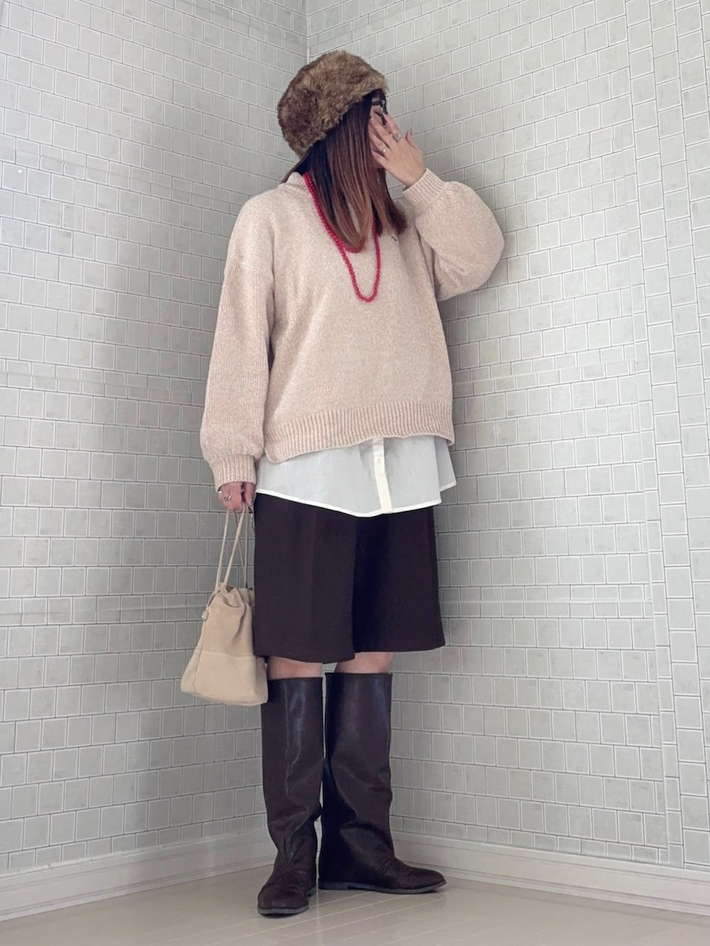 ベージュ系のニット/セーター、ブラウン系のその他パンツ、ブラウン系のブーツを着用したレディースの冬コーディネートの3枚目の写真