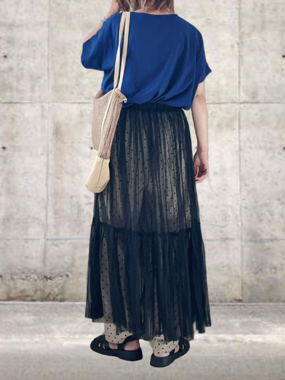 ブルー系のTシャツ/カットソー、ブラック系のスカート、ベージュ系のその他パンツを着用したレディースの秋コーディネートの3枚目の写真