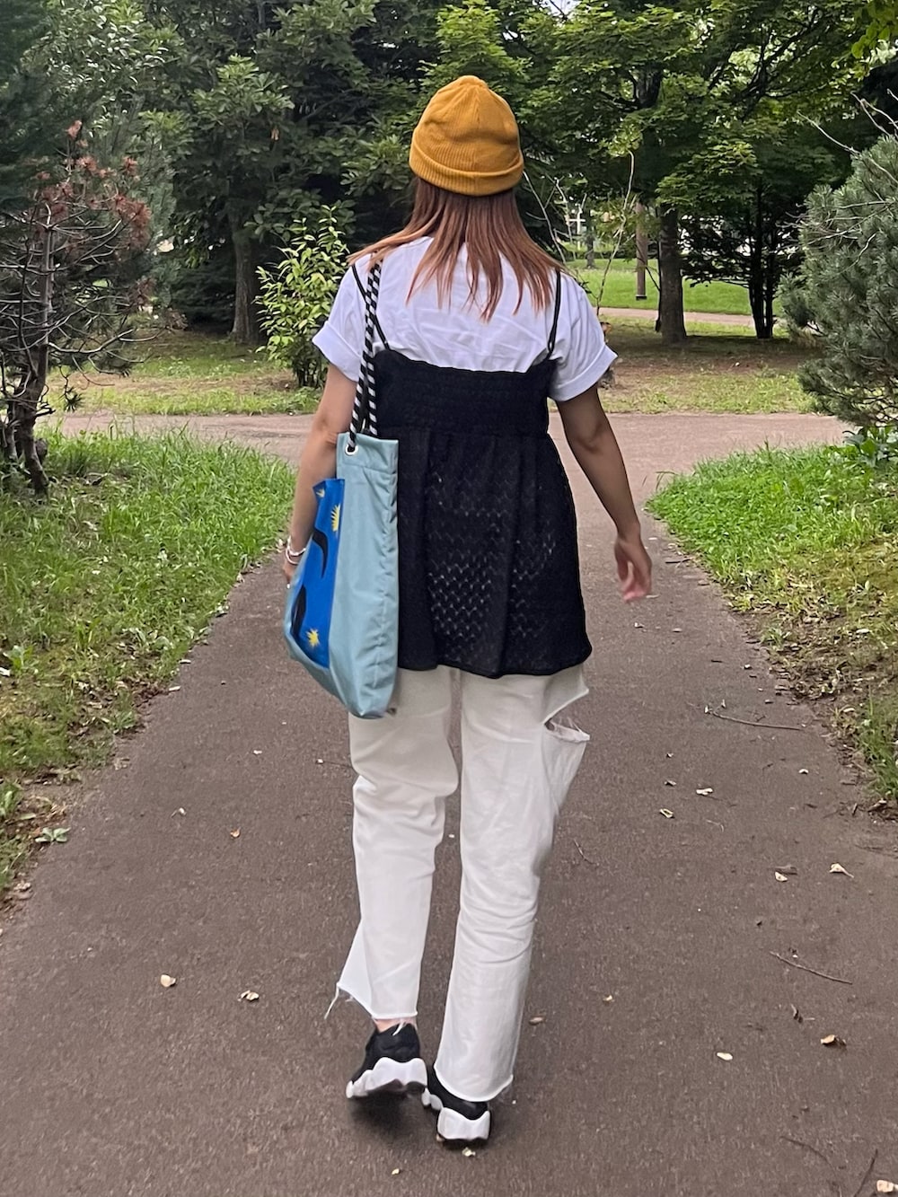 ホワイト系のデニムパンツ、ホワイト系のTシャツ/カットソー、ブラック系のTシャツ/カットソーを着用したレディースの夏コーディネートの3枚目の写真