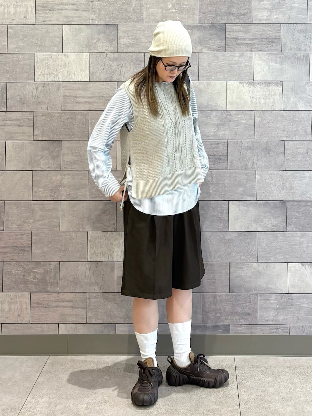 ベージュ系のTシャツ/カットソー、ブラウン系のショルダーバッグ、ブラウン系のスニーカーを着用したレディースの春コーディネートの2枚目の写真