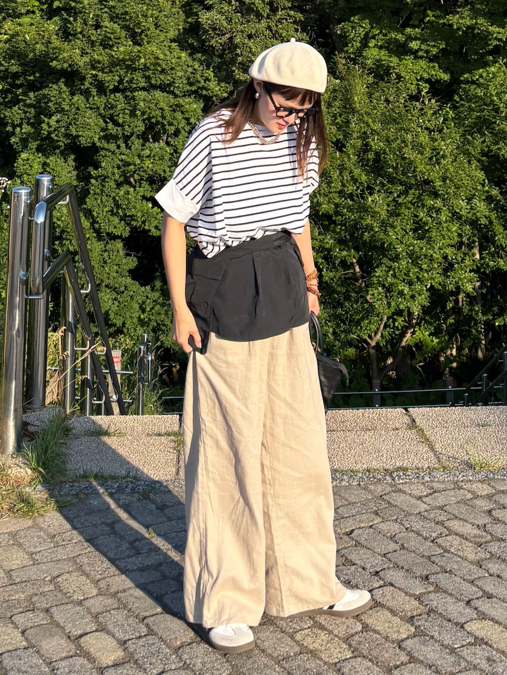 ベージュ系のその他パンツ、ホワイト系のTシャツ/カットソー、ホワイト系のスニーカーを着用したレディースの夏コーディネートの3枚目の写真