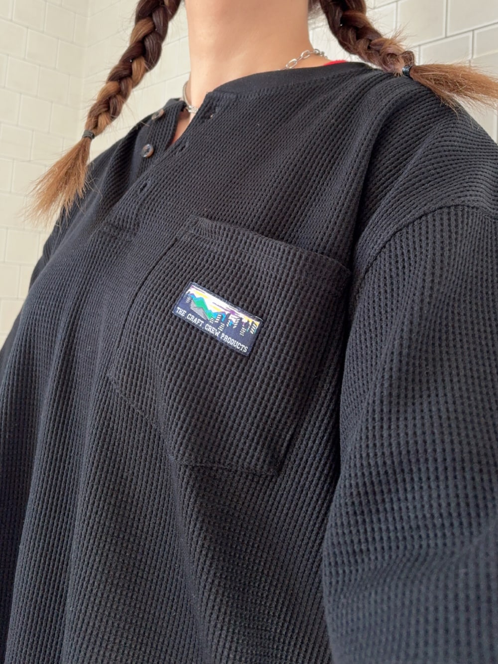 ブラック系のTシャツ/カットソー、ホワイト系のスニーカー、レッド系のキャップを着用したレディースの春コーディネートの5枚目の写真