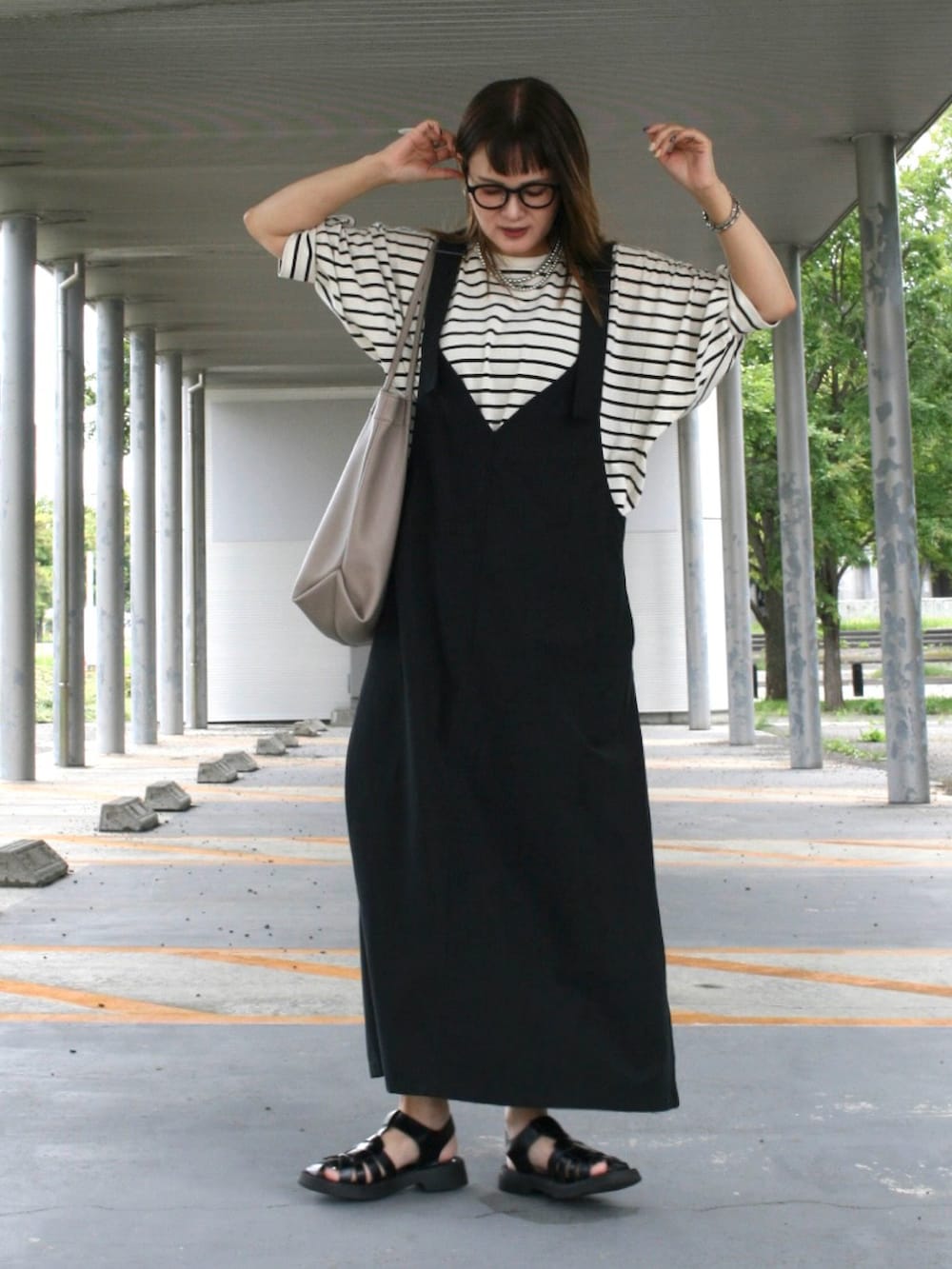 ブラック系のサンダル、その他のTシャツ/カットソー、ベージュ系のトートバッグを着用したレディースの夏コーディネートの5枚目の写真