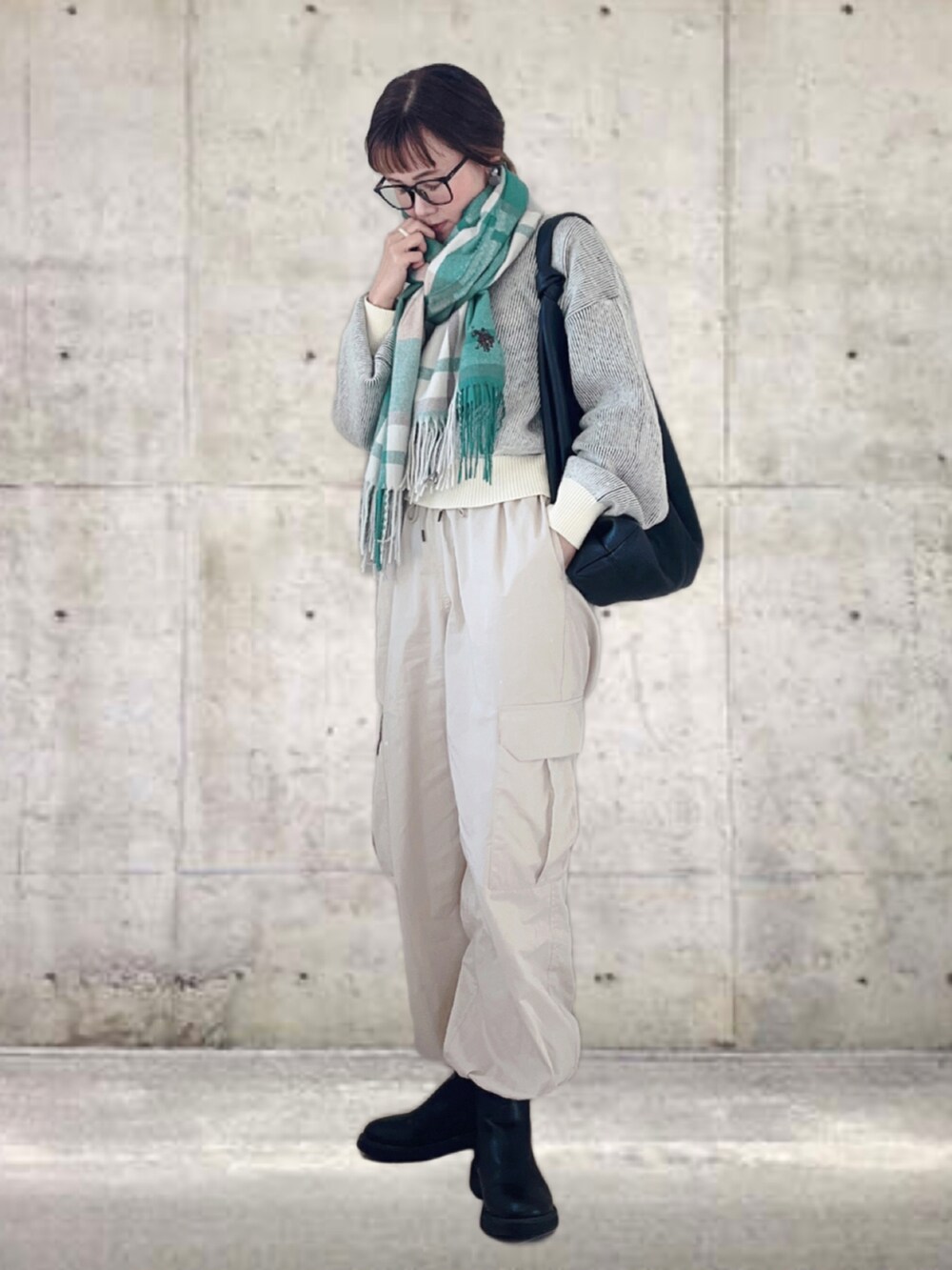 イエロー系のニット/セーター、ホワイト系のその他パンツ、ブラック系のトートバッグを着用したレディースの秋コーディネートの2枚目の写真