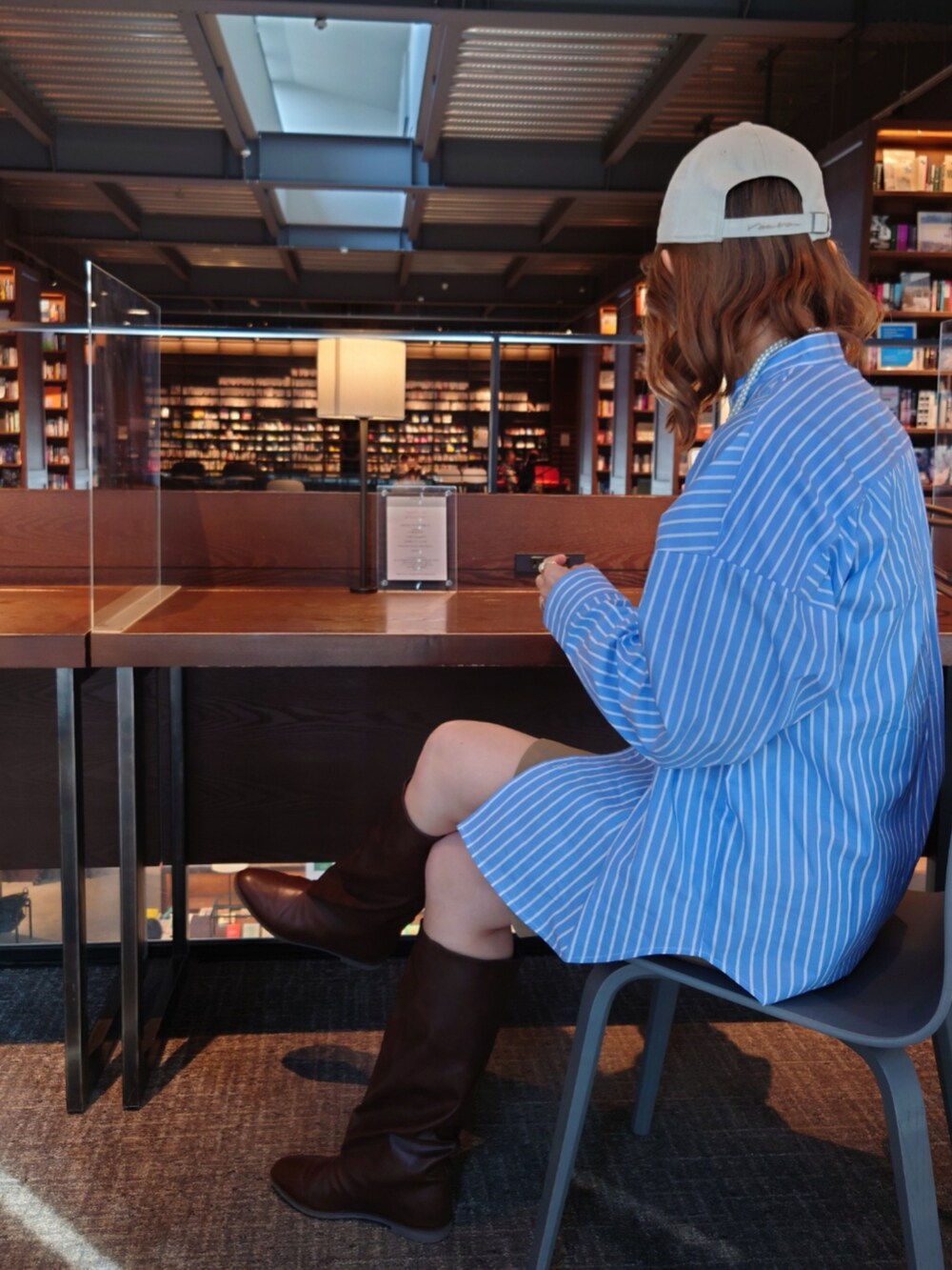 ブルー系のシャツ/ブラウス、ベージュ系のその他パンツ、ブラウン系のブーツを着用したレディースの春コーディネートの5枚目の写真