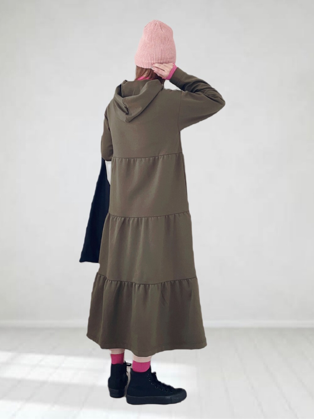 グリーン系のワンピース、ピンク系のTシャツ/カットソー、ブラック系のトートバッグを着用したレディースの春コーディネートの2枚目の写真