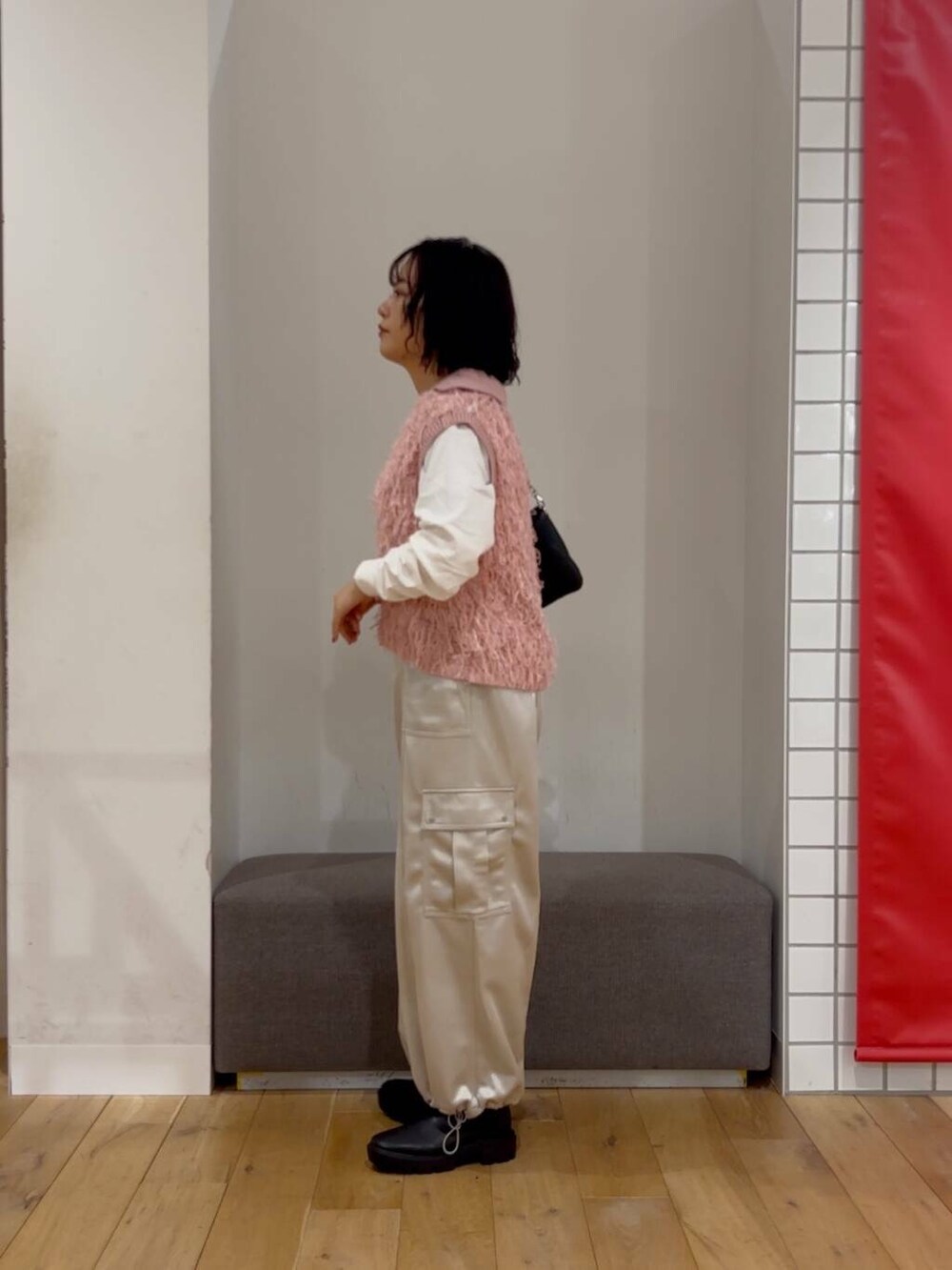 ブラック系のブーツ、その他のTシャツ/カットソー、ブラック系のショルダーバッグを着用したレディースの冬コーディネートの4枚目の写真