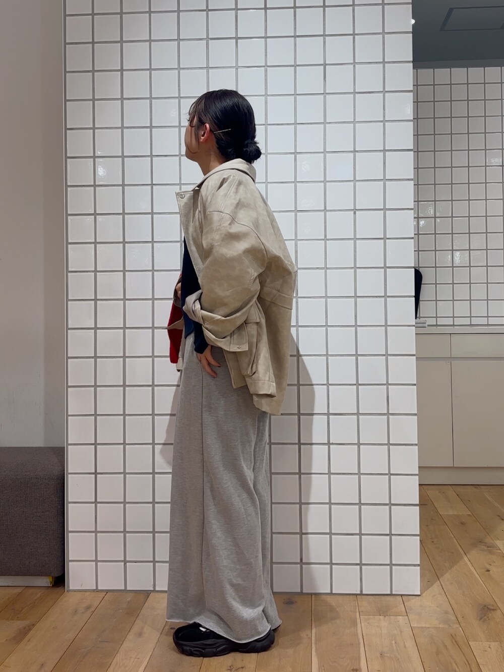 ホワイト系のその他アウター、ブルー系のニット/セーター、グレー系のスウェットパンツを着用したレディースの冬コーディネートの3枚目の写真