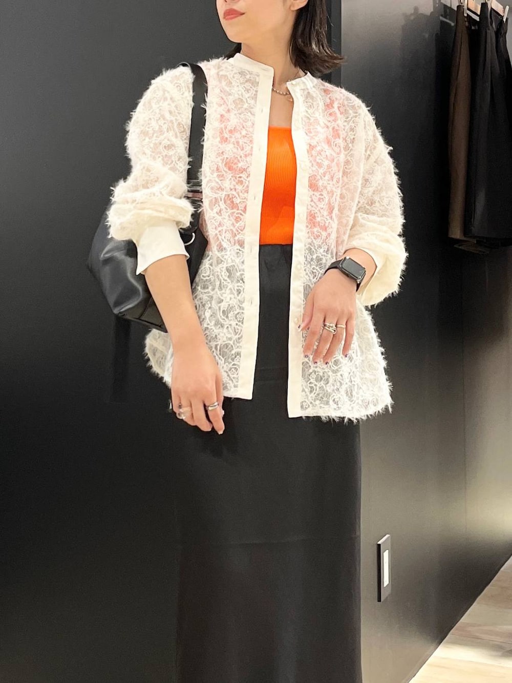 ホワイト系のタンクトップ、ブラック系のスカート、ブラック系のサンダルを着用したレディースの夏コーディネートの3枚目の写真