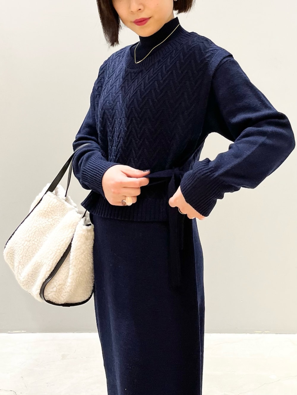 ホワイト系のバッグ、ブラウン系のブーツ、ブルー系のマタニティウェア/グッズを着用したレディースの冬コーディネートの2枚目の写真