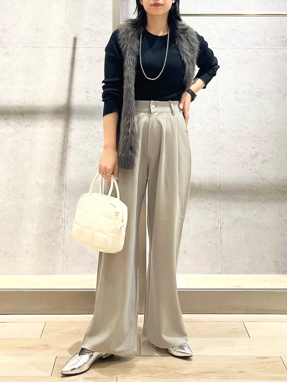 シルバー系のその他シューズ、ホワイト系のボストンバッグ、ブラック系のTシャツ/カットソーを着用したレディースの秋コーディネートの2枚目の写真