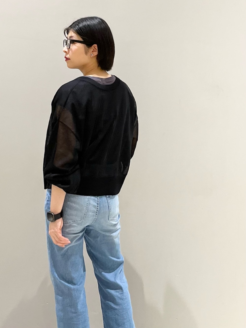 ホワイト系のサンダル、ホワイト系のショルダーバッグ、ブルー系のデニムパンツを着用したレディースの夏コーディネートの4枚目の写真