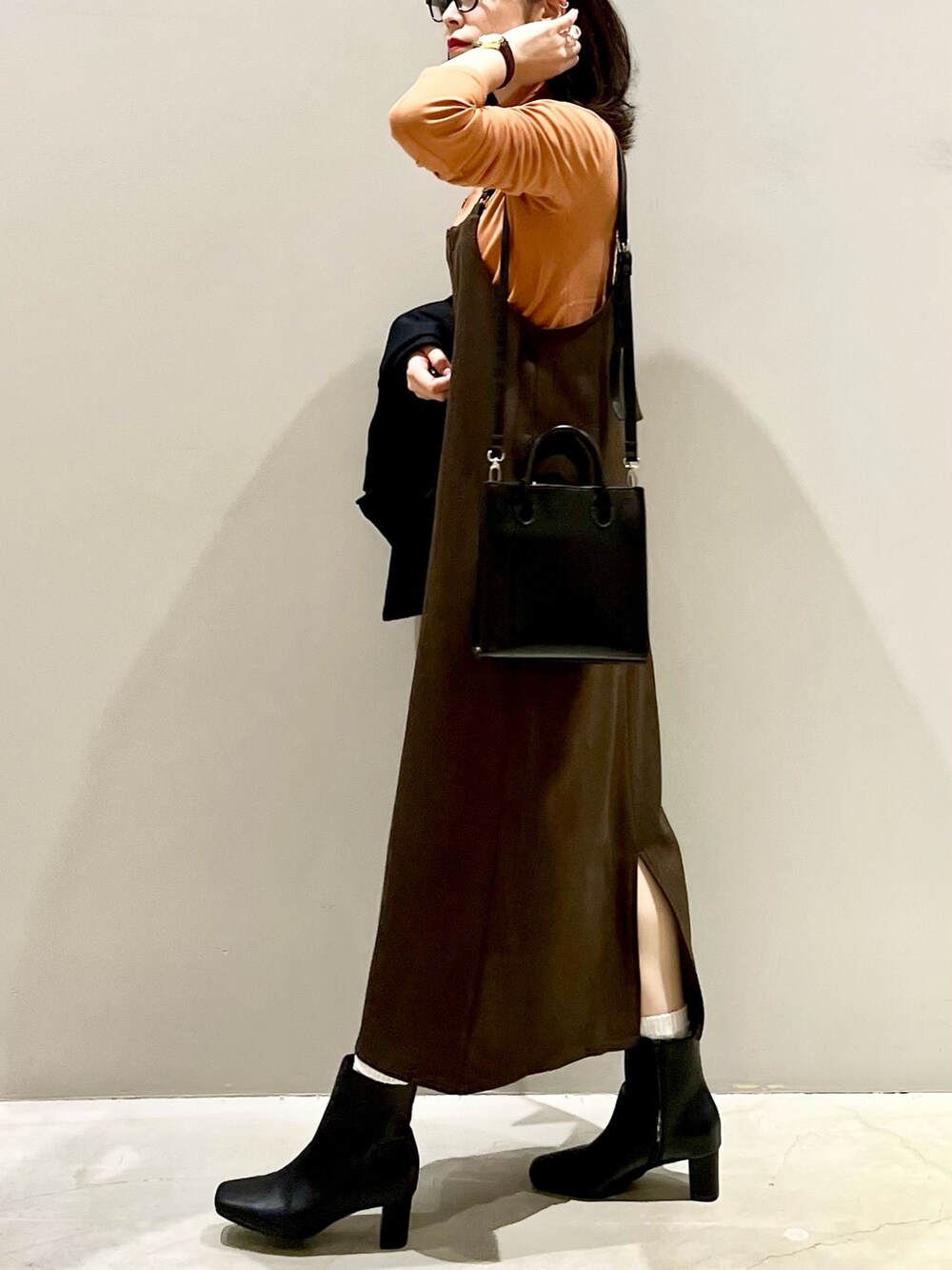 ブラウン系のワンピース、ブラック系のブーツ、ブラウン系のジャケット/アウターを着用したレディースの冬コーディネートの5枚目の写真