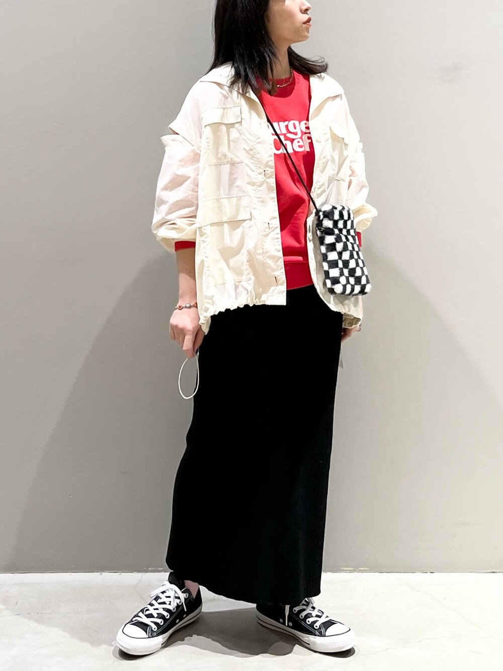 ブラック系のスカート、ブラック系のスニーカー、その他のバッグを着用したレディースの秋コーディネートの2枚目の写真