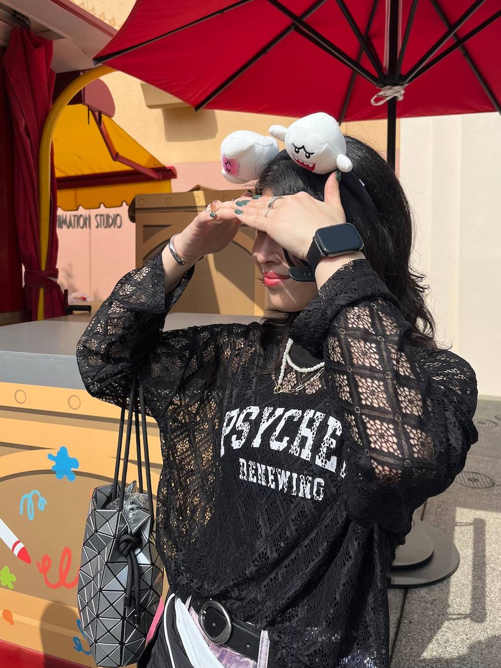 パープル系のデニムパンツ、ブラック系のTシャツ/カットソー、ホワイト系のネックレスを着用したレディースの春コーディネートの2枚目の写真