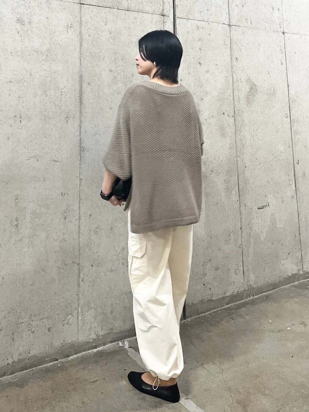 ブラック系のショルダーバッグ、ホワイト系のカーゴパンツ、ブラック系のパンプスを着用したレディースの春コーディネートの4枚目の写真