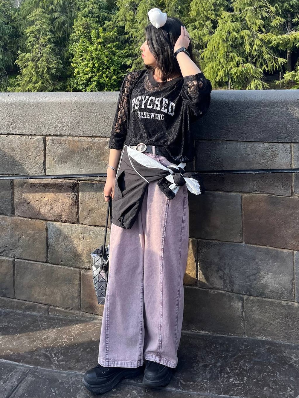 パープル系のデニムパンツ、ブラック系のTシャツ/カットソー、ホワイト系のネックレスを着用したレディースの春コーディネートの5枚目の写真