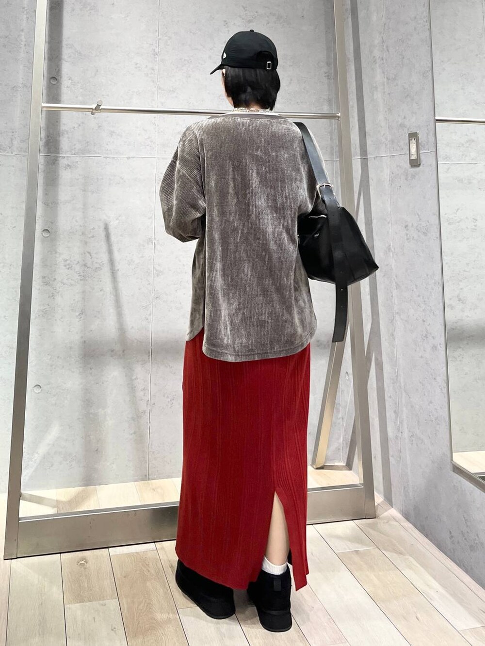 ブラック系のショルダーバッグ、ブラック系のブーツ、グレー系のTシャツ/カットソーを着用したレディースの冬コーディネートの6枚目の写真