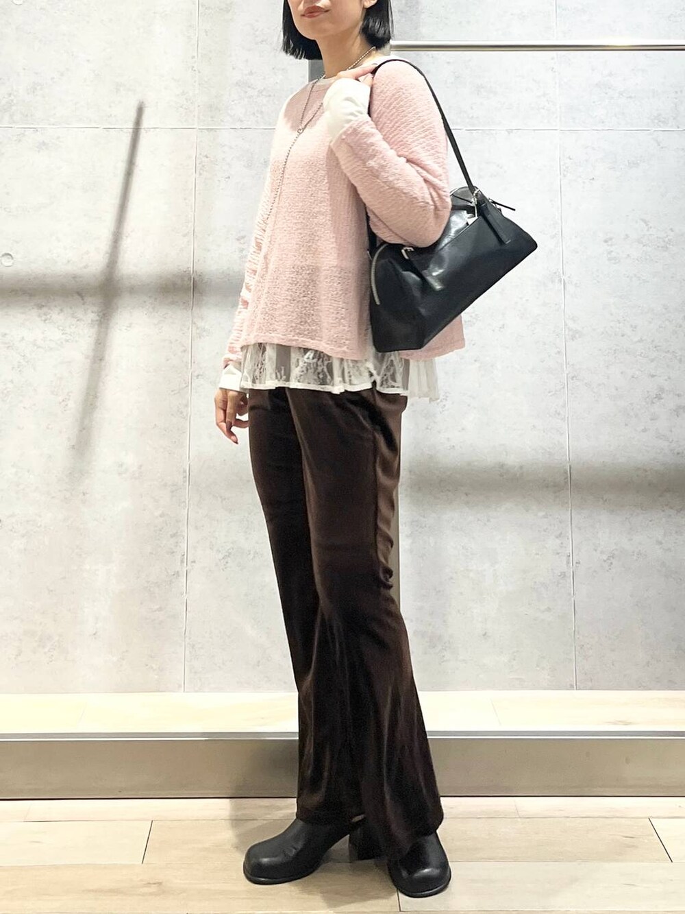 ピンク系のニット/セーター、ブラウン系のその他パンツ、ブラック系のその他シューズを着用したレディースの秋コーディネートの3枚目の写真